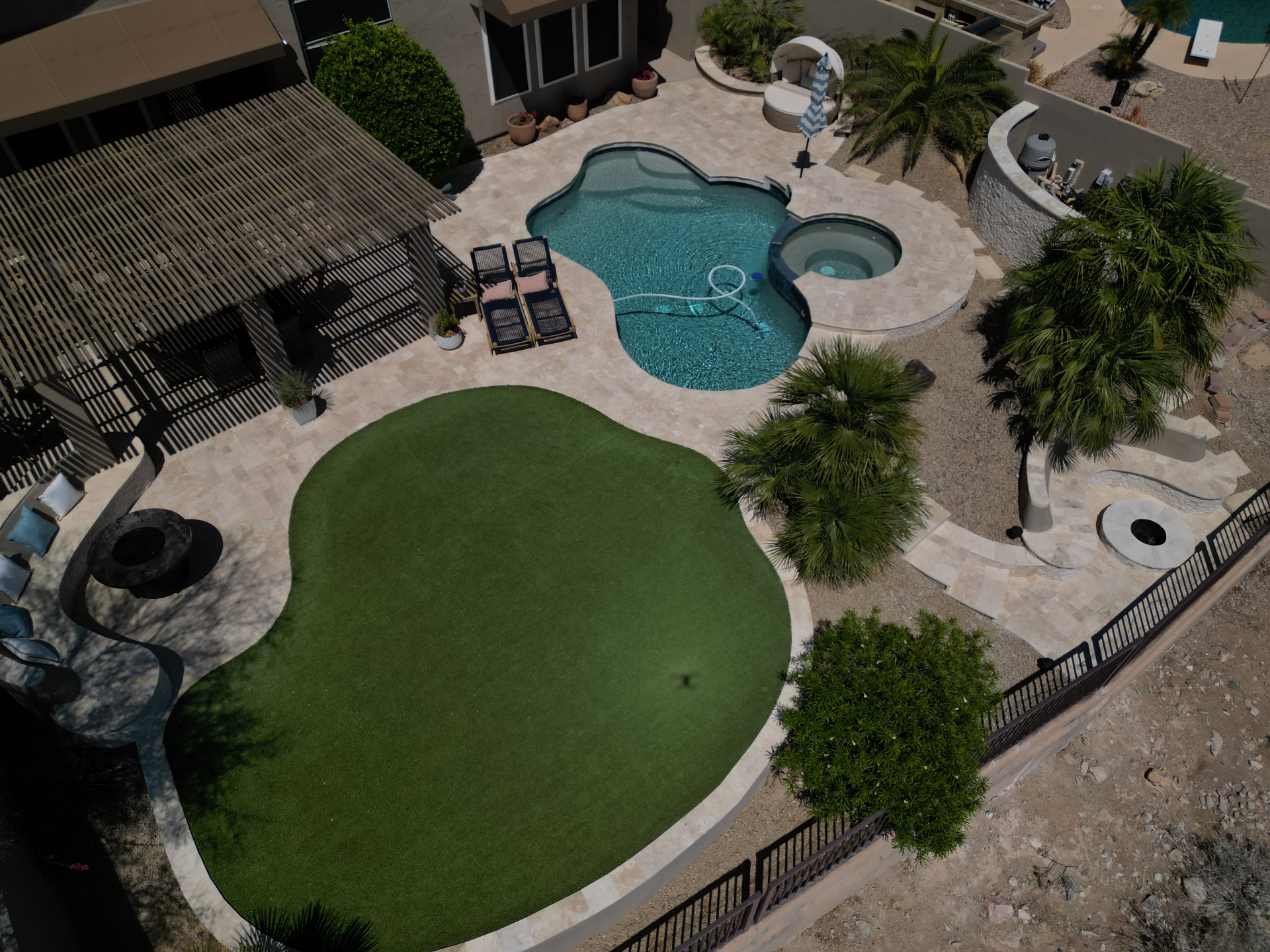 Aerial view of Arizona travertine pool deck with putting green